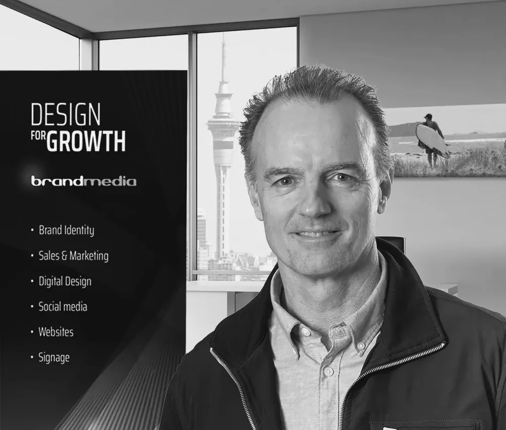 Jeff Watkins, founder of Brandmedia, in front of a Design for Growth banner